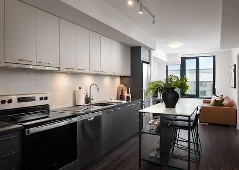 a kitchen with stainless steel appliances and a white counter top